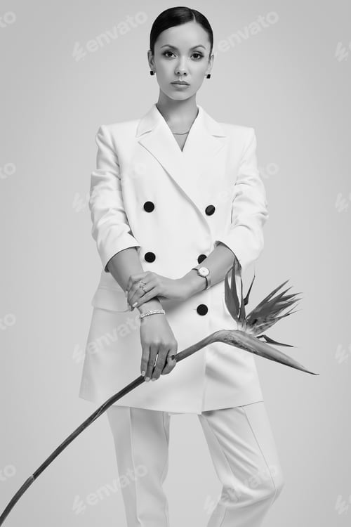 Preview: Portrait Of A Cute And Gorgeous Latin Women In Fashion White Suit With Exotic Flower Posing On