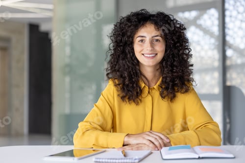 Preview: Confident Businesswoman Sitting at a Desk with Notebooks and Digital Tablet
