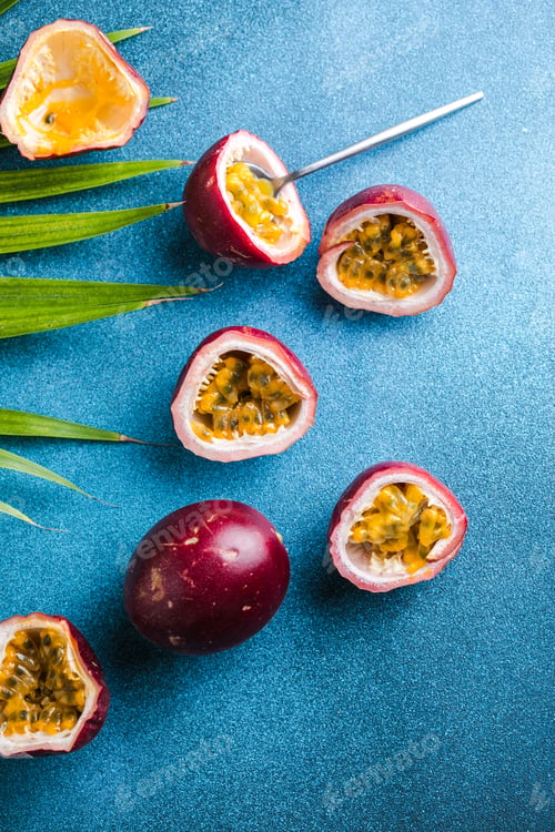 Preview: Ripe passion fruit, half and slice of fruit on a blue background.