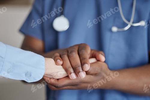 Preview: Youll always have my support. Shot of two unrecognizable doctors holding hands at a hospital.
