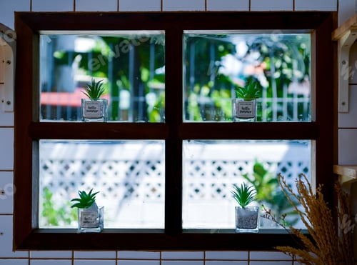 Preview: The kitchen window is decorated with flower pots. The outside natural light illuminates
