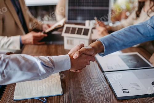 Preview: Close up of businesmans shaking hands in office.
