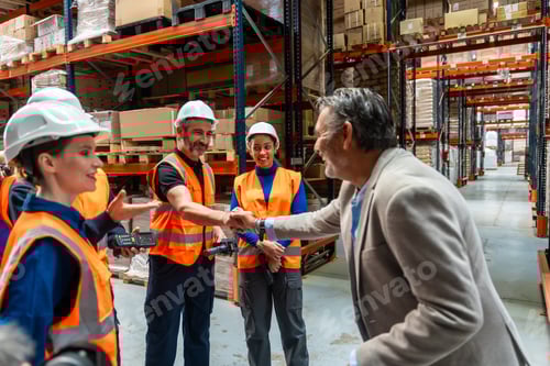 Preview: Business manager shaking hands with warehouse workers