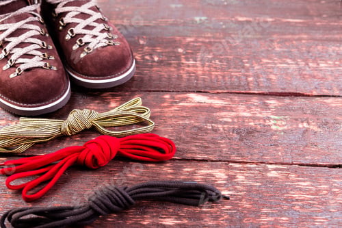 Preview: Brown man suede boots and shoelaces on wooden background. Autumn or winter shoes.