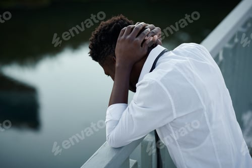 Preview: Man in depression standing on bridge
