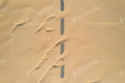 Preview: Closeup shot of roads of unfinished construction covered by the desert sands