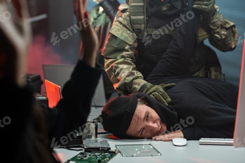 Preview: Network criminal being taken by men in camouflage outfit