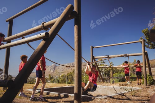 Preview: Trainer assisting kids in obstacle course training