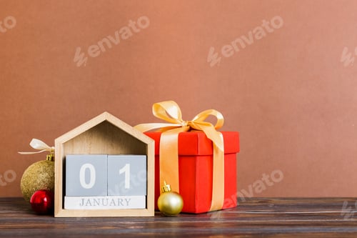 Preview: 1 january. Christmas composition on colored background with a wooden calendar