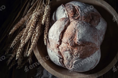 Preview: Brown loaf of bread with grain and ears