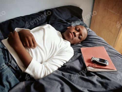 Preview: Teenage boy lying on bed