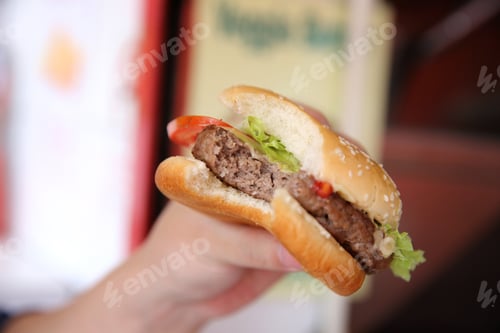 Preview: Beef Hamburger Eating On A Man Hand In Close Up