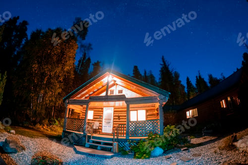 Preview: wooden cottage in the woods with starry milky way at night in the sky, night sky with stars
