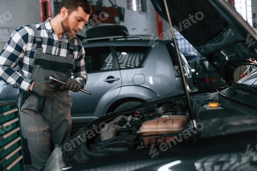 Preview: Man in uniform is working in the auto salon
