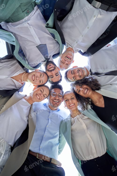 Preview: Multiracial diverse group office men women colleagues hugging in circle looking down smiling camera.
