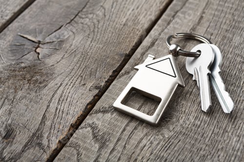 Preview: Bunch of keys with house shaped keychain on rustic wood