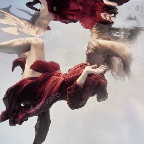 Preview: A Woman In A Red Dress Underwater As If Floating In Weightlessness