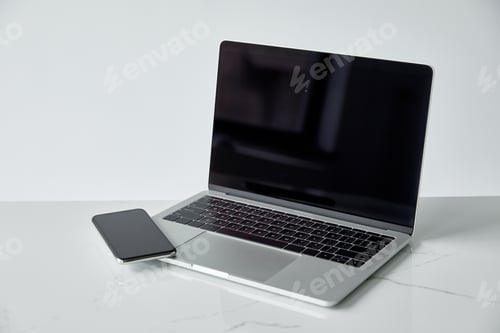 Preview: laptop and smartphone with blank screen isolated on grey with copy space