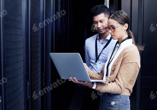 Preview: No one knows networking like they do. Shot of two technicians working together in a server room.