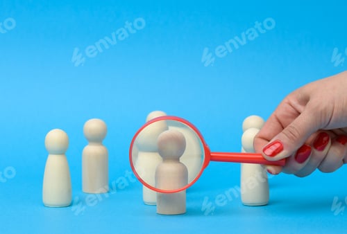 Vista previa: Wooden figures of men stand on a blue background and a red magnifying glass