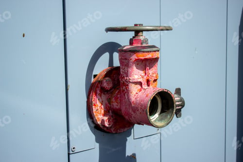 Preview: Closeup shot of an old industrial valve on a blue background