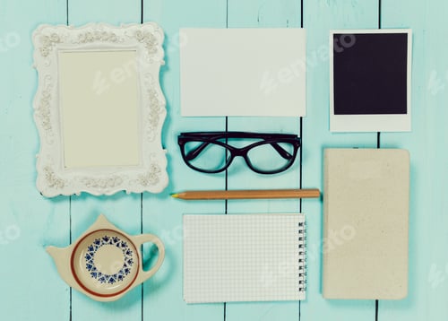 Preview: Creative workspace arrangement with stationery and decorative items on blue wooden surface