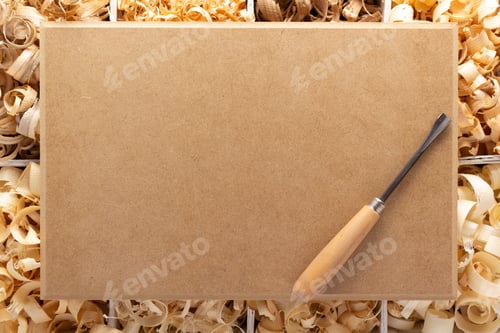 Preview: Wood shavings in box on table background. Wooden shaving at old plank board