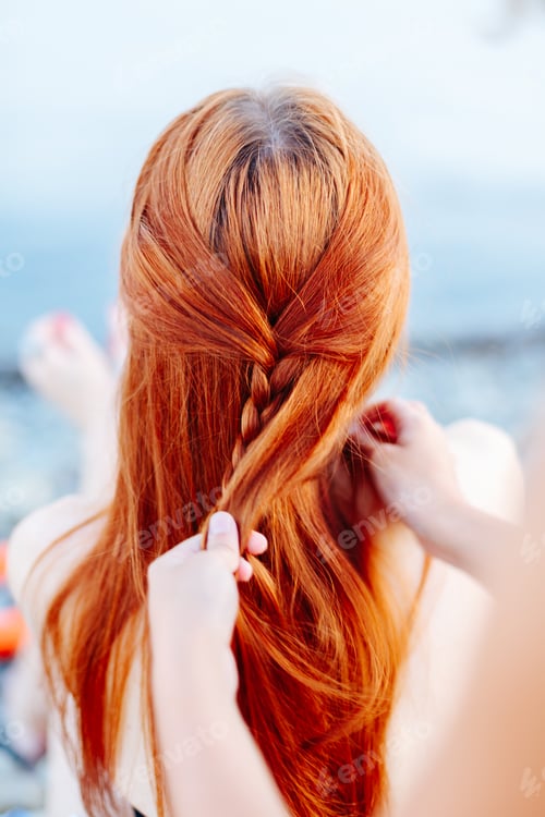 Preview: Woman braiding girl on beach