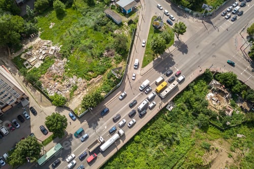 Preview: Top down aerial view of busy street intersection with moving cars traffic.
