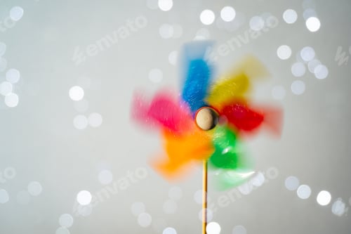 Preview: Colorful turning pinwheel on shiny white background