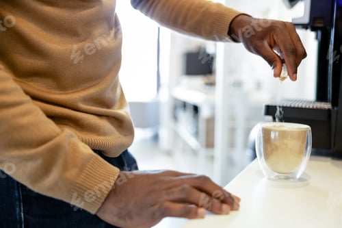 Preview: Anonymous multiracial man worker making a cup of hot coffee in the office kitchen