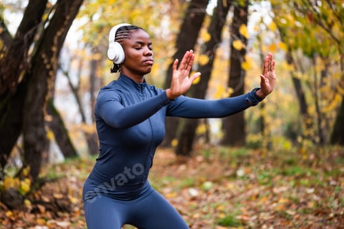 Focused Woman Meditates in a Forest, Autumn Season