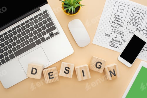 Preview: top view of gadgets near wooden blocks with design lettering, website design template and green