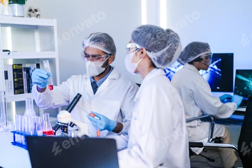 Preview: diverse team of scientists collaborates in a genetics lab. A male researcher explains a procedure