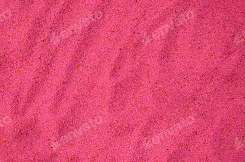 Preview: Texture of a colored granular sand close up. Pink grains