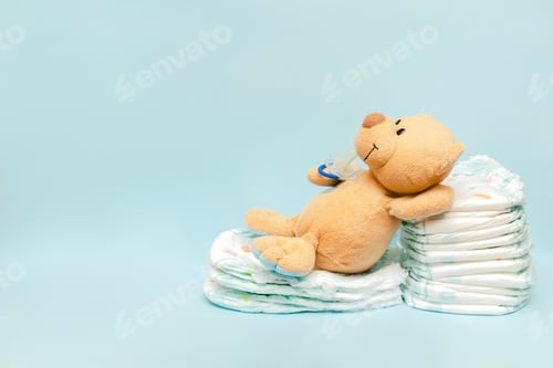 Preview: diapers with teddy bear toy lying on table.infant newborn boy girl for baby shower present gift
