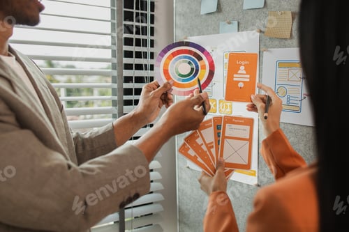 Preview: UI UX designers team working on new website wireframe in office