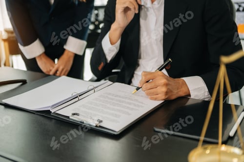 Preview: Business and lawyers discussing contract papers with brass scale on desk in office. Law, legal