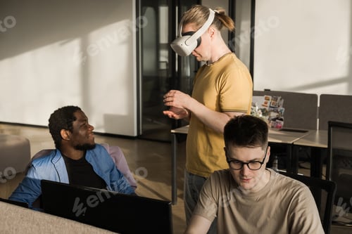 Preview: IT Development Team Working on VR Project. Man wearing VR headset, playing and touching something in