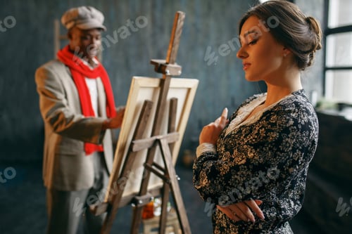 Preview: Portrait painter at the easel draws female model