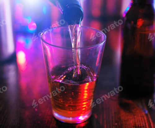 Preview: pouring beer from bottle into glass with colorful lighting at pub