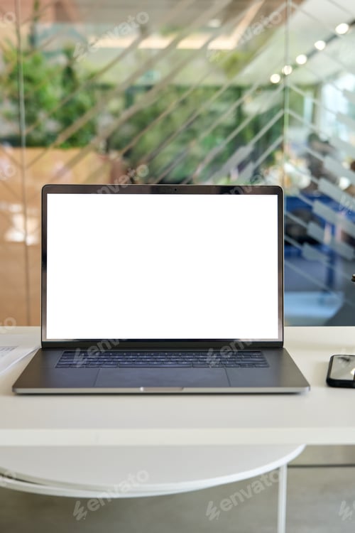 Preview: Workplace in modern office with white empty mock up screen pc laptop computer.