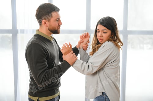 Preview: Man beating up his wife illustrating domestic violence