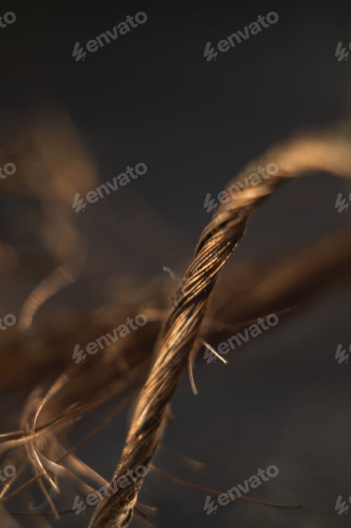 Preview: Vertical shot of a bare copper wire on a dark background