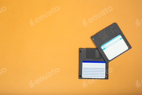 Preview: Old floppy disks on a bright orange background with space for text or design