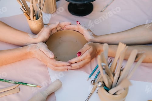 Preview: Pottery workshop outdoors with participants shaping clay
