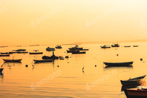 Preview: Beautiful view of fishing boats in the sea at sunset
