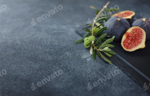 Preview: fresh ripe figs fruit and olive branch on dark table