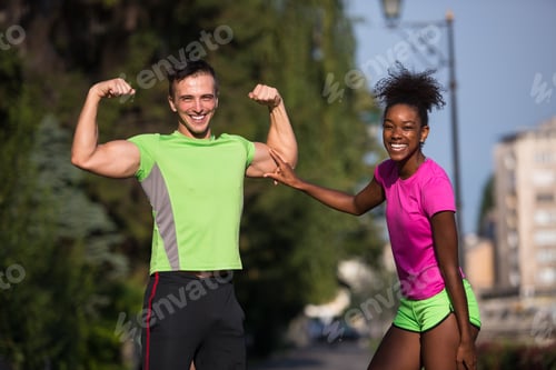 Preview: portrait of young multietnic jogging couple ready to run