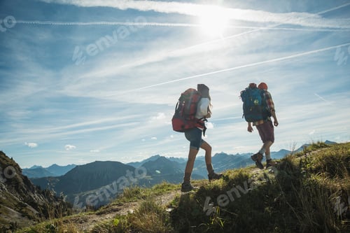 Preview: Austria, Tyrol, Tannheimer Tal, young couple hiking on mountain trail